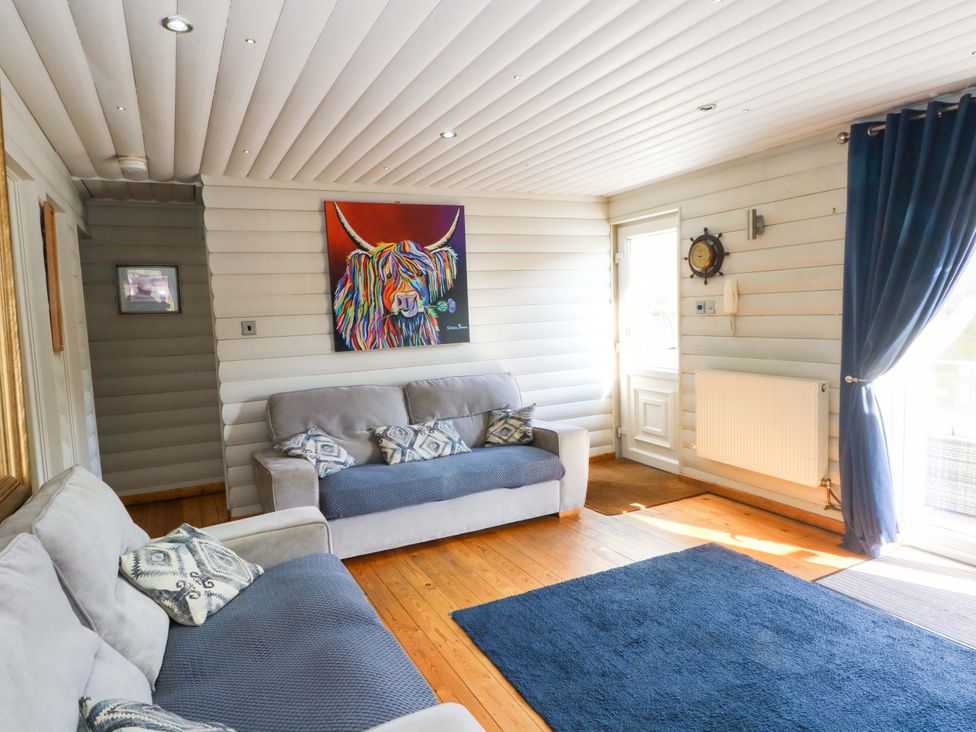 A living room with a sofa and painting at The Bothy in Leek