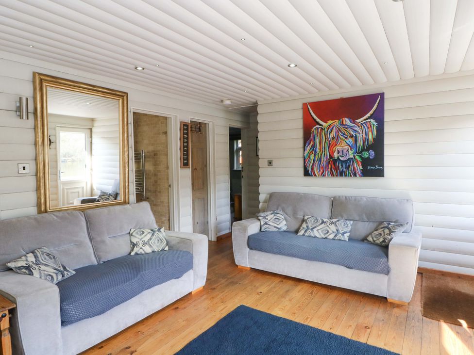 A living room with two sofas and an artwork on the wall at The Bothy in Leek