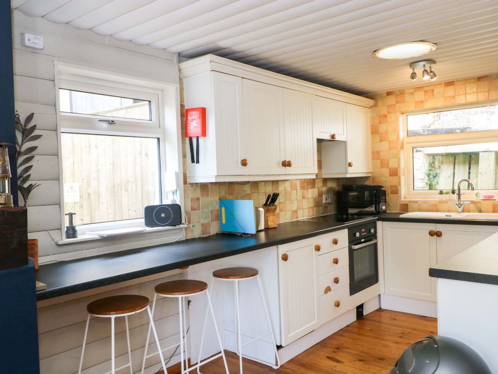 A kitchen with cabinets and appliances at The Bothy in Leek