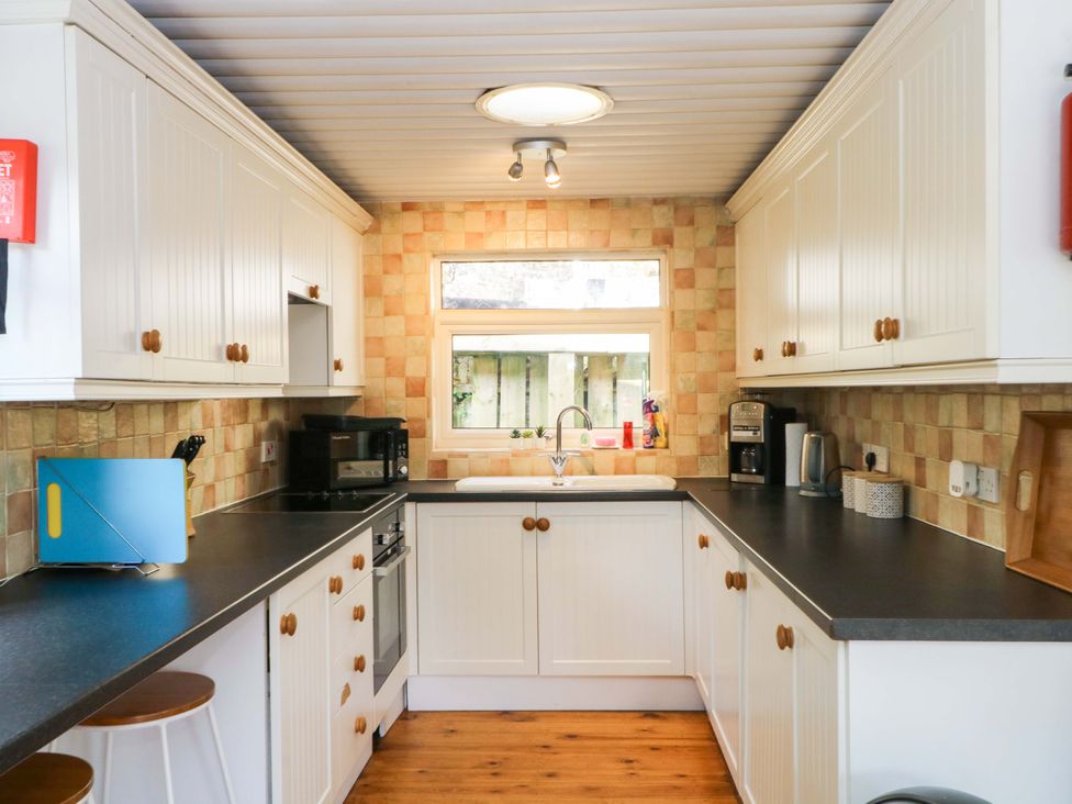 A kitchen with a sink and appliances at The Bothy in Leek