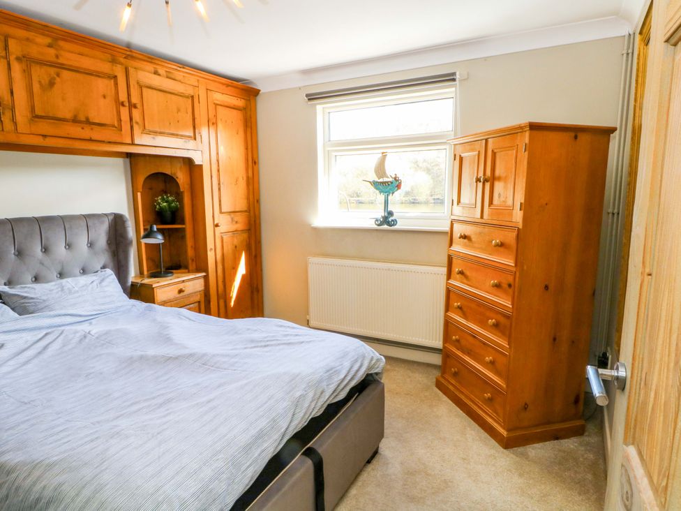 A bedroom with a bed and dresser at The Bothy in Leek