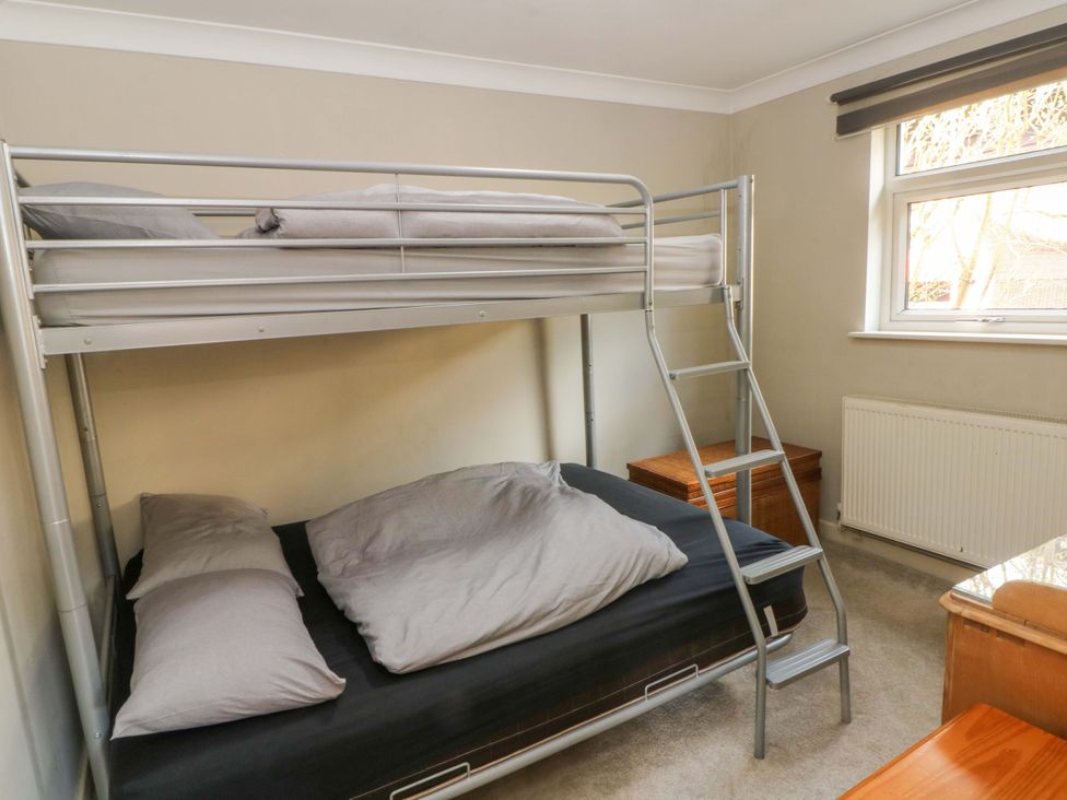 A bedroom with a bunk bed and a window at The Bothy in Leek