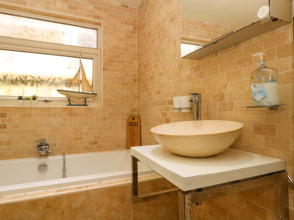 A bathroom with a sink and bathtub at The Bothy in Leek
