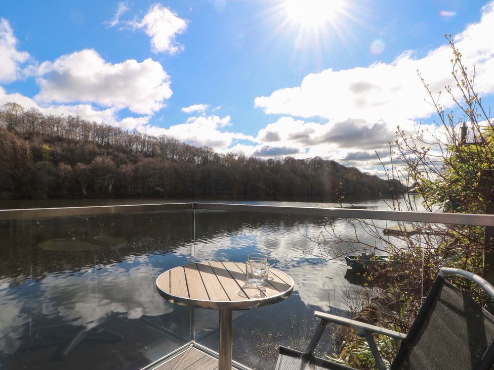 A table with a glass near a river at The Bothy in Leek