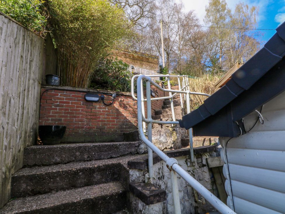 A garden with steps and a railing at The Bothy in Leek