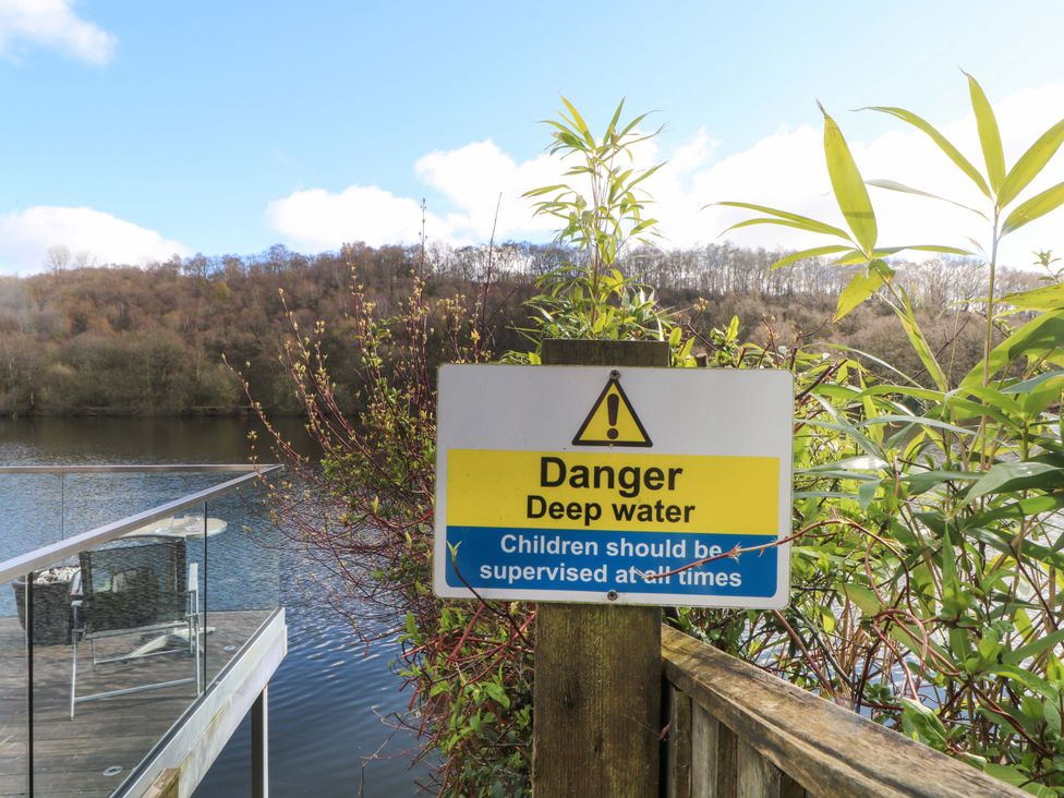 A warning sign about deep water near a lake at The Bothy in Leek