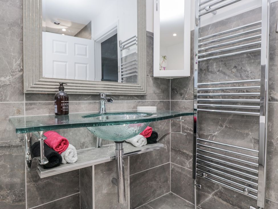 A bathroom with a sink and mirror at Hazelodge in Coniston