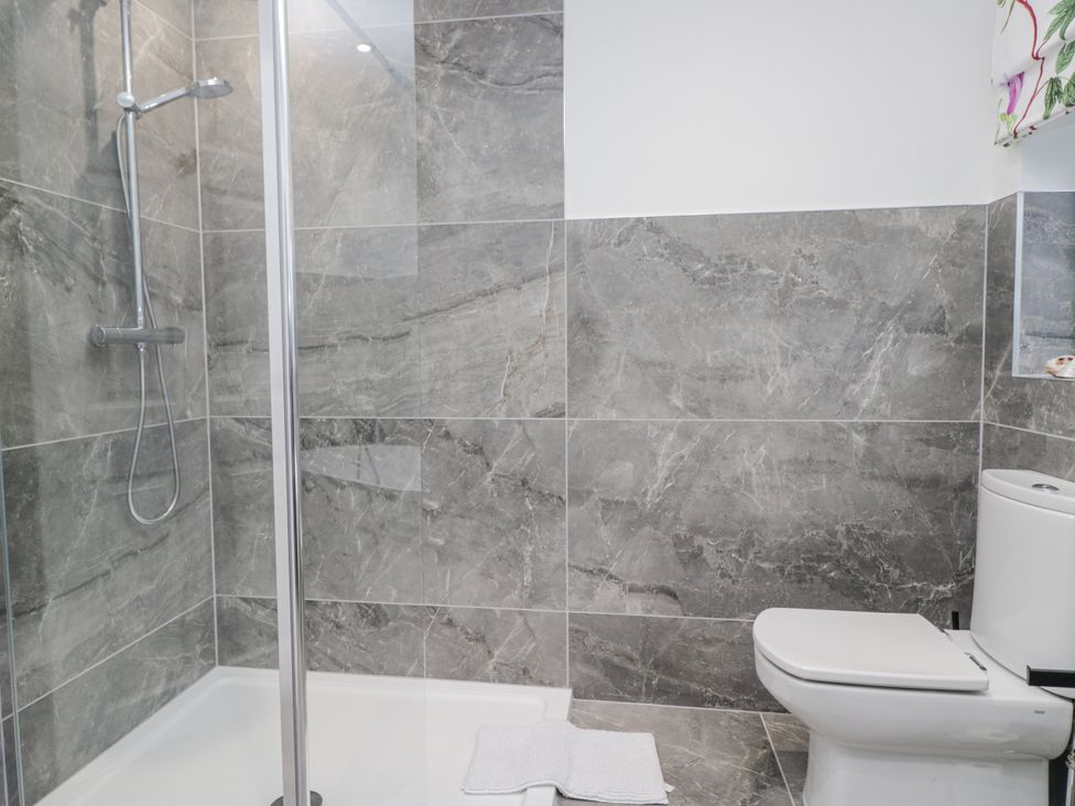 A bathroom with a shower and toilet at Hazelodge in Coniston