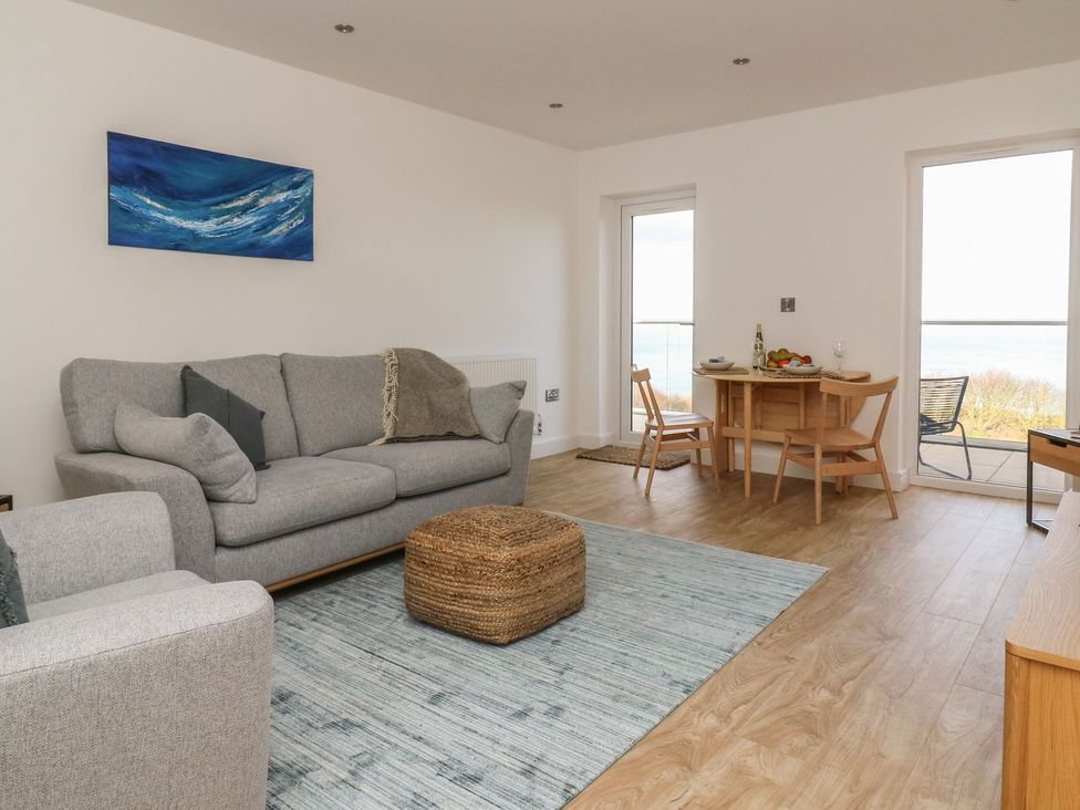 A living room with a sofa and dining area at The Lookout in 