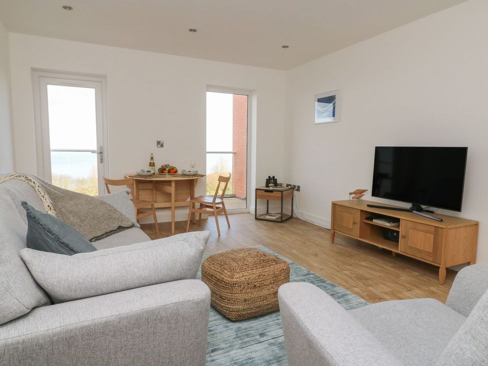 A living room with a dining area and television at The Lookout