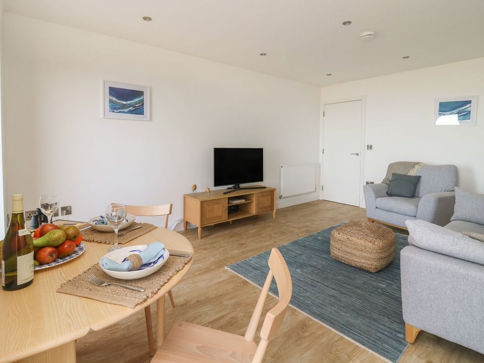 A living room with a table and sofa at The Lookout