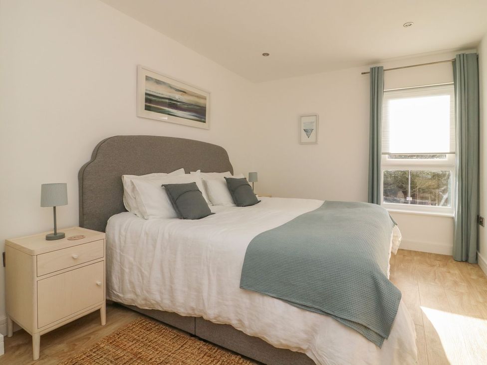 A bedroom with a bed and bedside table at The Lookout