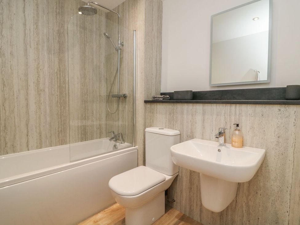 A bathroom featuring a bathtub, shower, toilet, and sink at The Lookout