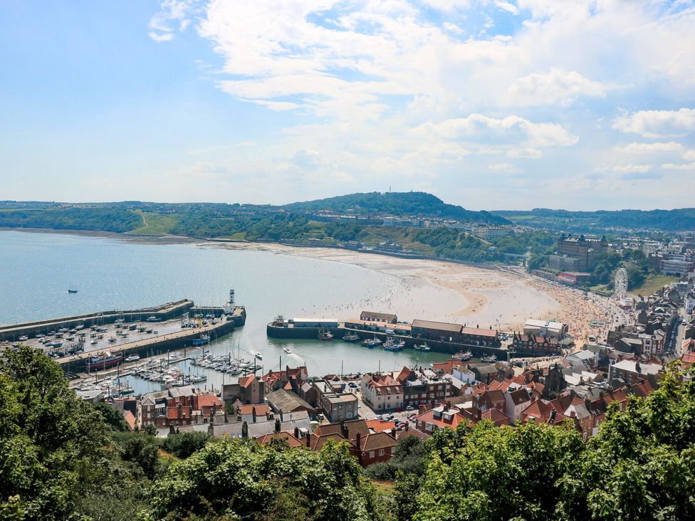 A coastal view of a beach with boats and harbor at The Lookout in 