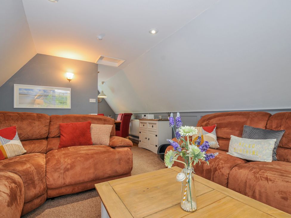 A living room with a sofa and table at Hideaway Cottage in St Ann's Chapel, Cornwall