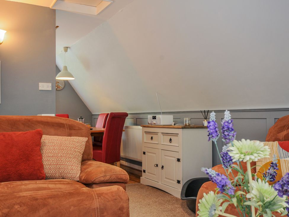 A living room with a sofa and table at Hideaway Cottage St Ann's Chapel, Cornwall