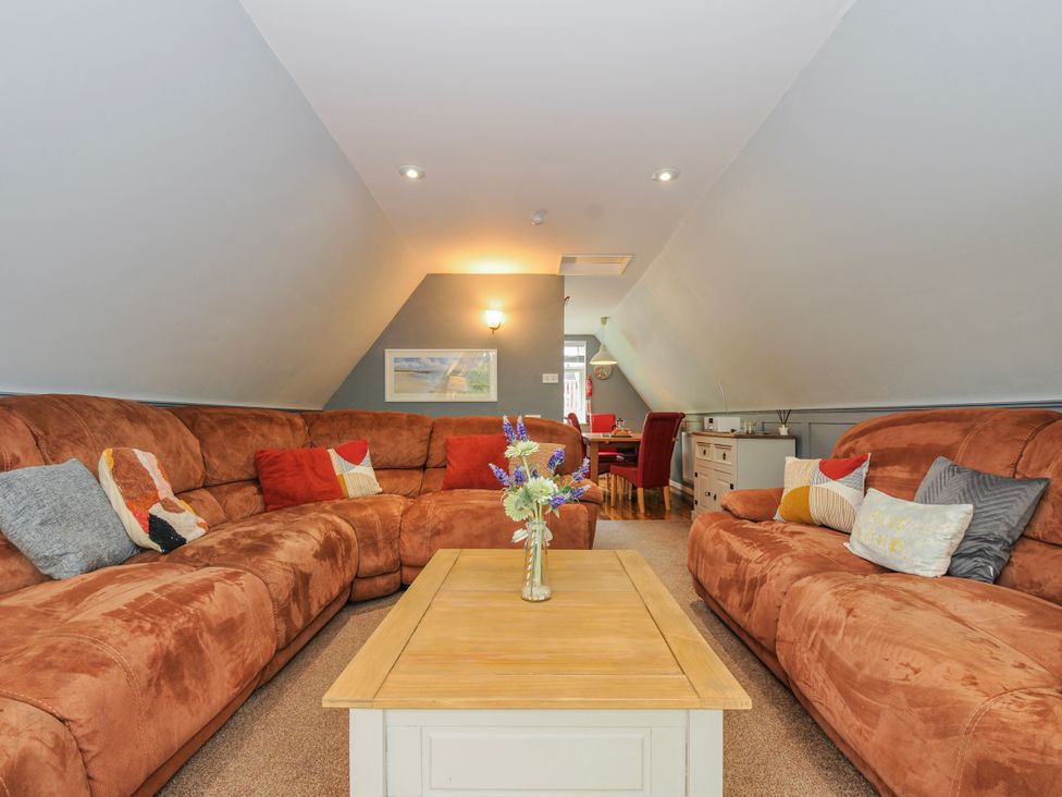 A living room with a sofa and coffee table at Hideaway Cottage, St Ann's Chapel, Cornwall