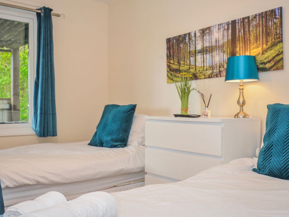 A bedroom with two beds and a dresser at Hideaway Cottage, St Ann's Chapel, Cornwall