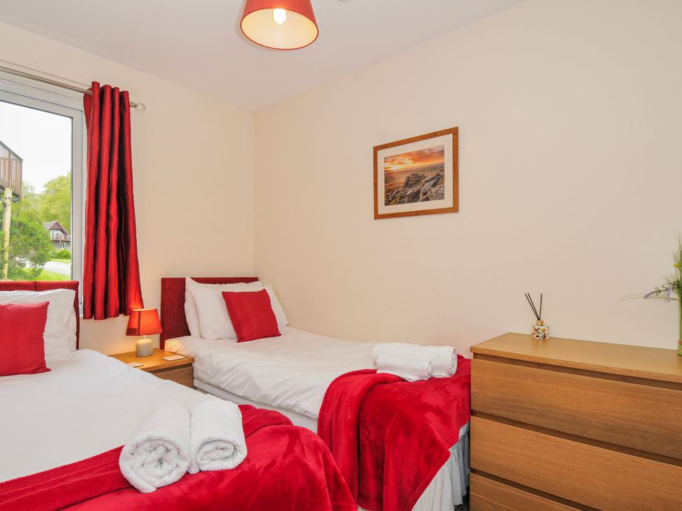 A bedroom with two beds and a window at Hideaway Cottage, St Ann's Chapel, Cornwall