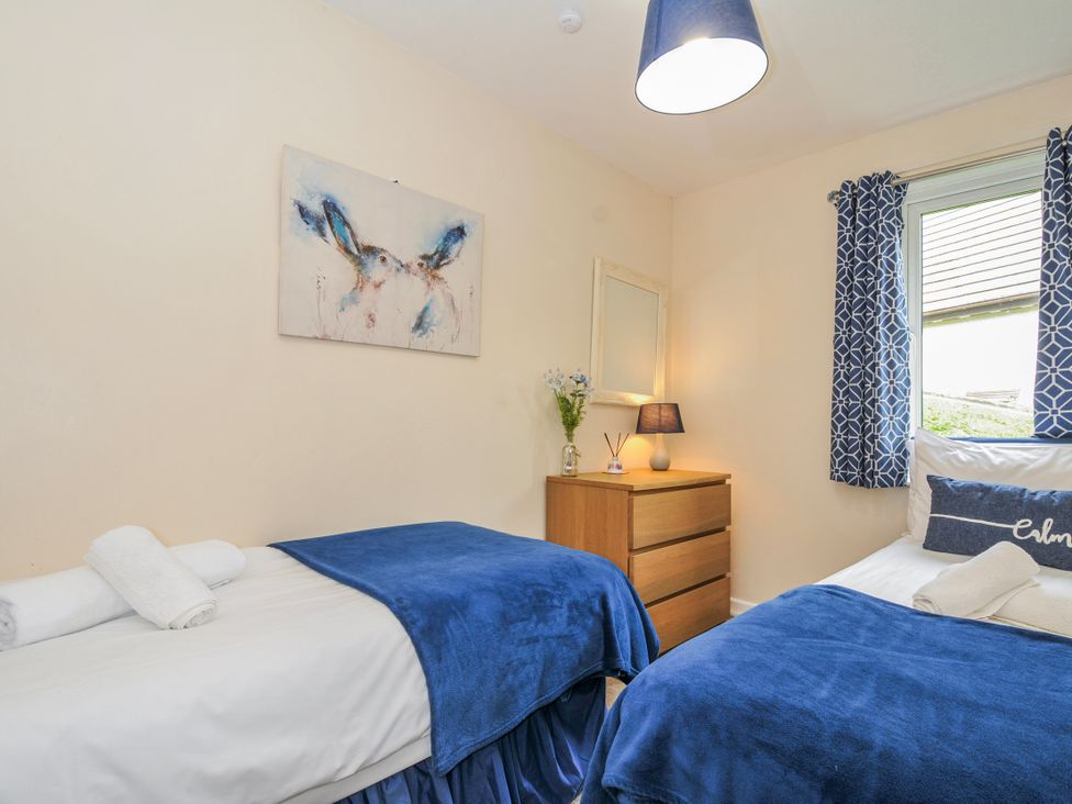 A bedroom with two beds and a dresser at Hideaway Cottage St Ann's Chapel Cornwall