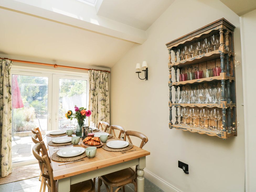 A dining room with a table set for meal at Mallards in Bourton-On-The-Water
