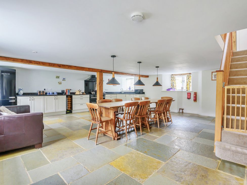 A dining room with a table and chairs at Middle Dean Farmhouse in Trentishoe near Parracombe