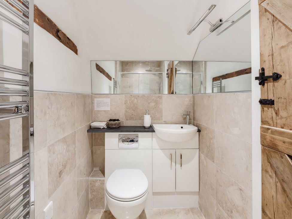 A bathroom with a sink and toilet at Middle Dean Farmhouse near Trentishoe