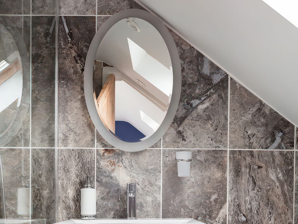 A bathroom with a mirror and sink at Middle Dean Farmhouse in Trentishoe near Parracombe