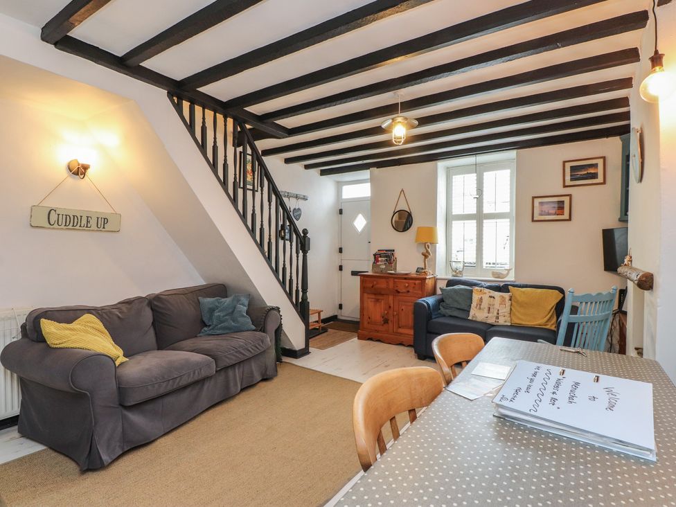 A living room with a sofa and table at Menuchah in Criccieth