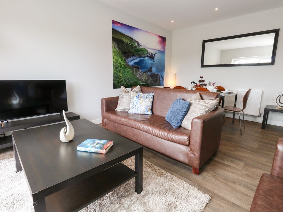 A living room with a sofa and coffee table at Durbyfield in Nottington near Weymouth