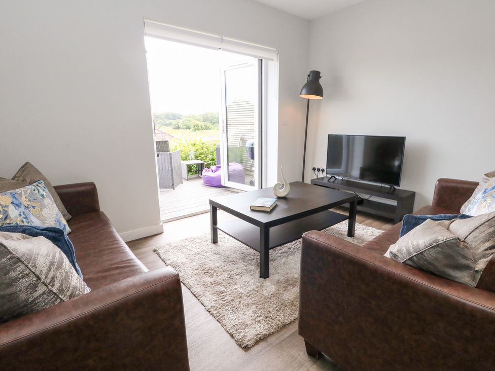 A living room with a coffee table and television at Durbyfield Nottington near Weymouth