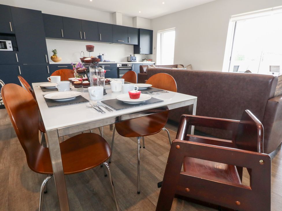 A kitchen with a dining table and chairs at Durbyfield in Nottington near Weymouth