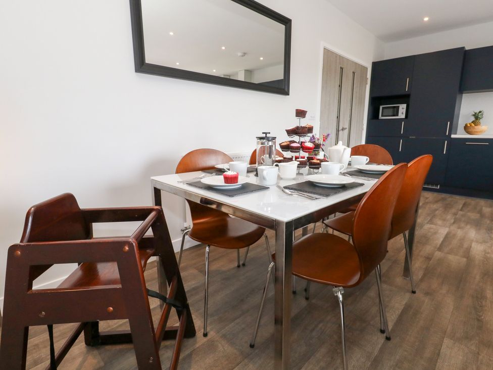 A dining room with a table set for tea at Durbyfield in Nottington near Weymouth