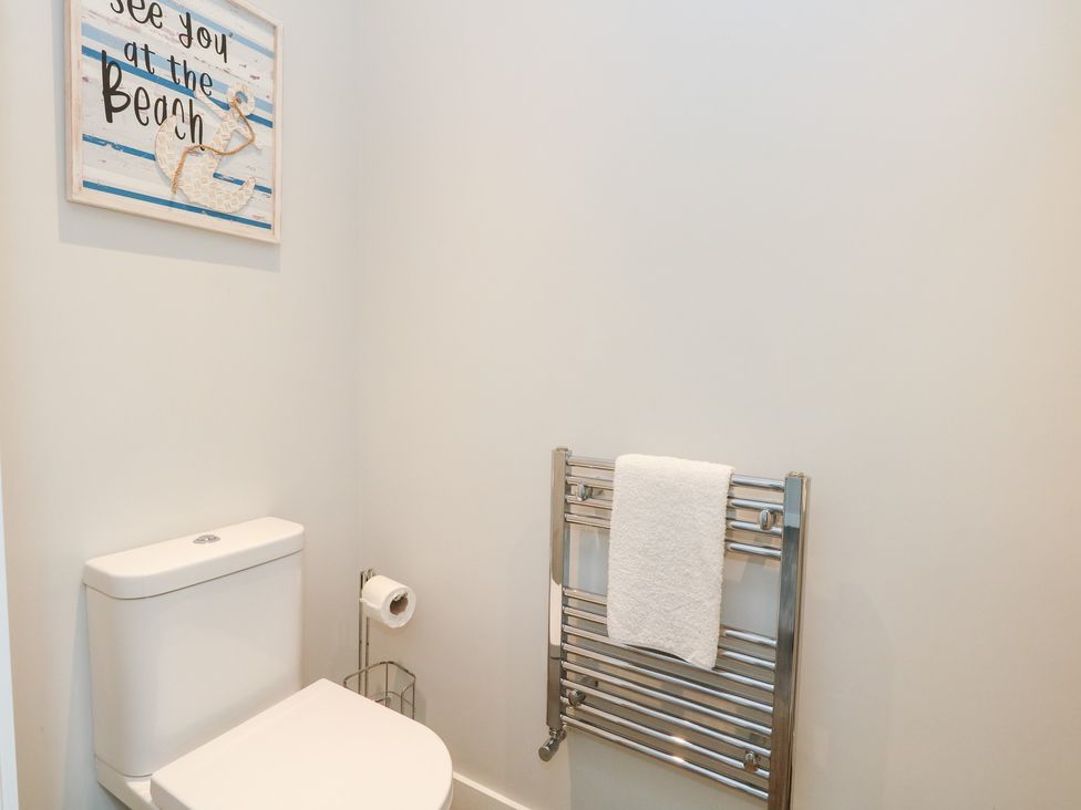 A bathroom with a toilet and towel rack at Durbyfield in Nottington near Weymouth