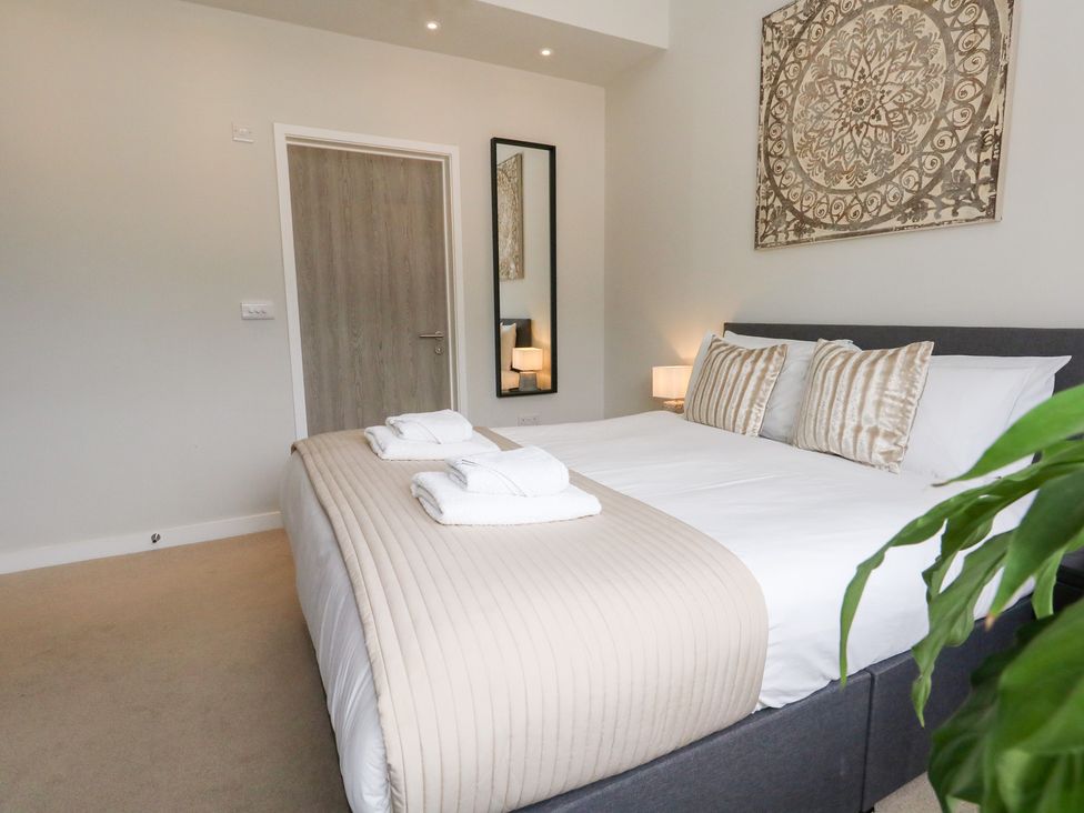 A bedroom with a bed and lamp at Durbyfield in Nottington near Weymouth