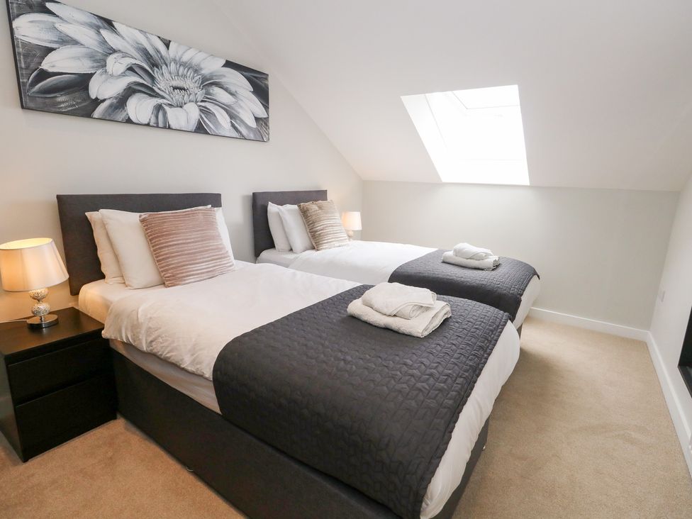A bedroom with two beds and a lamp at Durbyfield Nottington near Weymouth