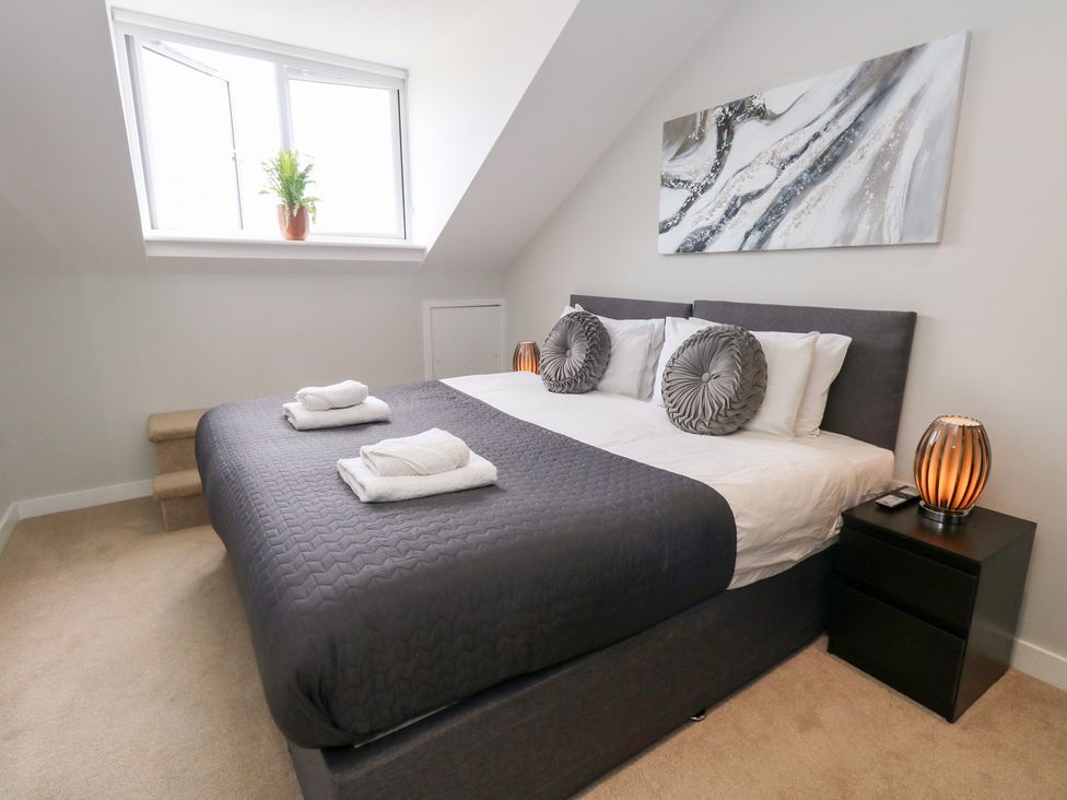 A bedroom with a double bed and a window at Durbyfield in Nottington near Weymouth