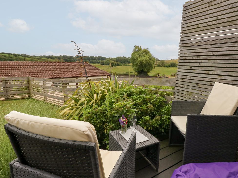 An outdoor seating area with chairs and a table at Durbyfield Nottington near Weymouth