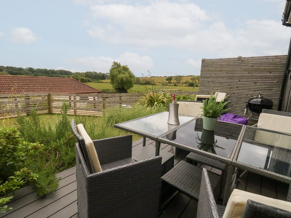 An outdoor patio with table and chairs at Durbyfield Nottington near Weymouth