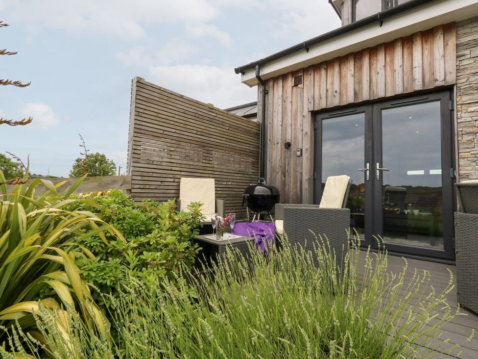 An outdoor area with chairs and a table at Durbyfield in Nottington near Weymouth