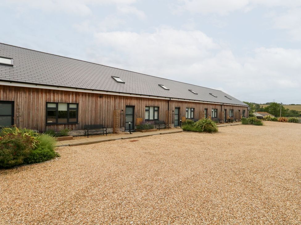 An outdoor area with a building and benches at Egdon Heath Nottington near Weymouth