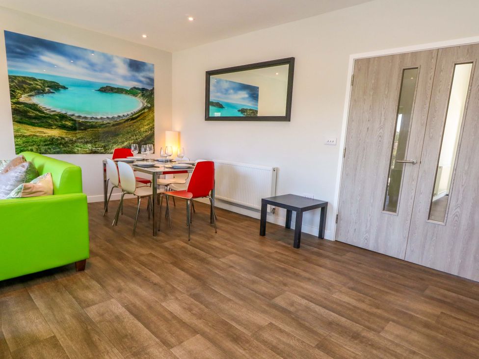 A living room with a table and chairs at Overcombe Mill in Nottington near Weymouth