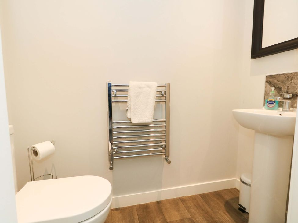 A bathroom with a toilet and hand basin at Overcombe Mill Nottington near Weymouth