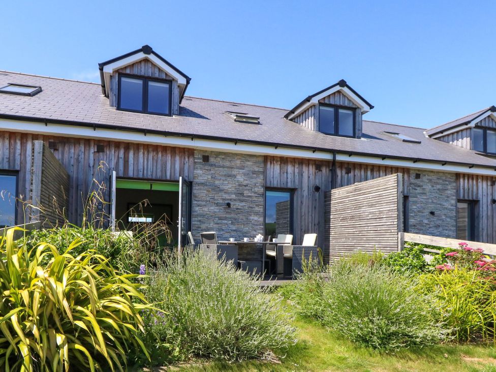 A building with an outdoor seating area and garden at Overcombe Mill Nottington near Weymouth
