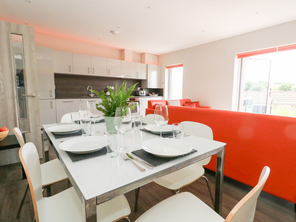 A dining area with a table set for dinner at Corvesgate in Nottington near Weymouth