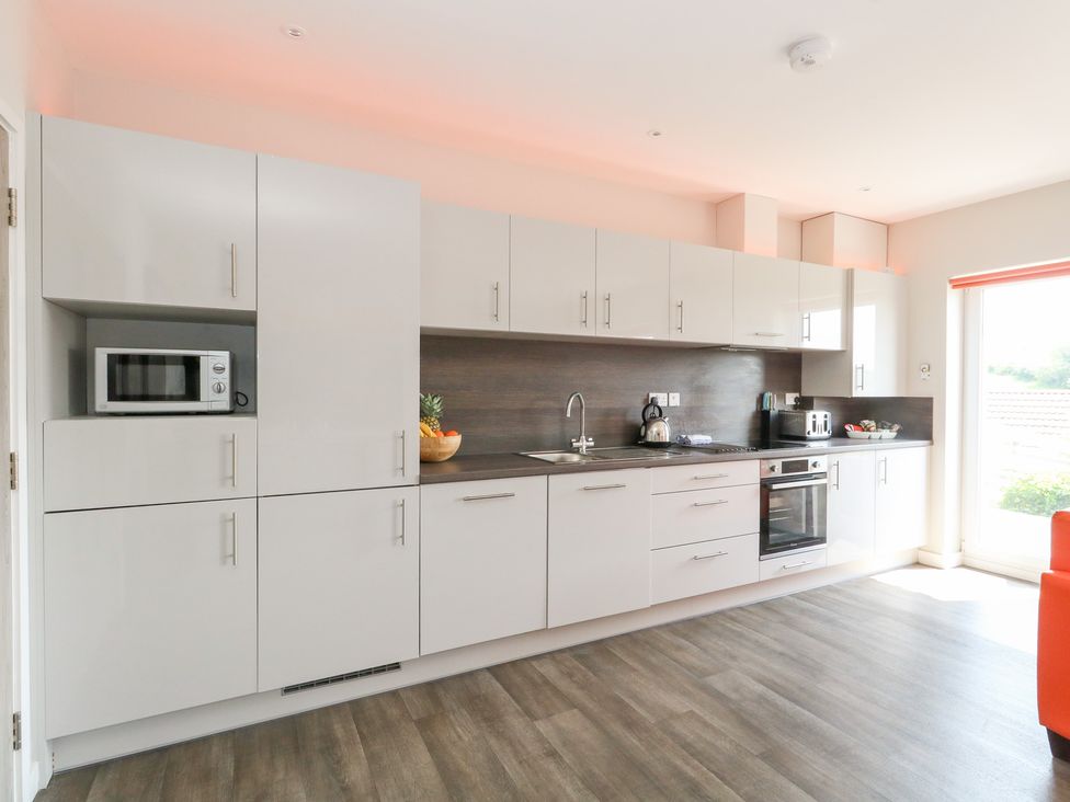 A kitchen with cabinets and appliances at Corvesgate in Nottington near Weymouth