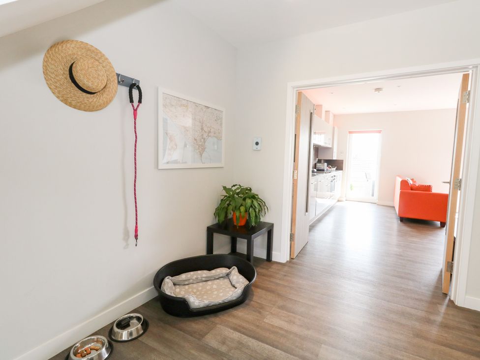A hallway with a plant and a pet bed at Corvesgate Nottington near Weymouth