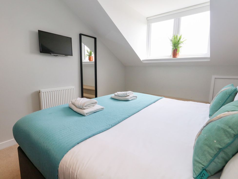 A bedroom with a bed and a television at Corvesgate Nottington near Weymouth