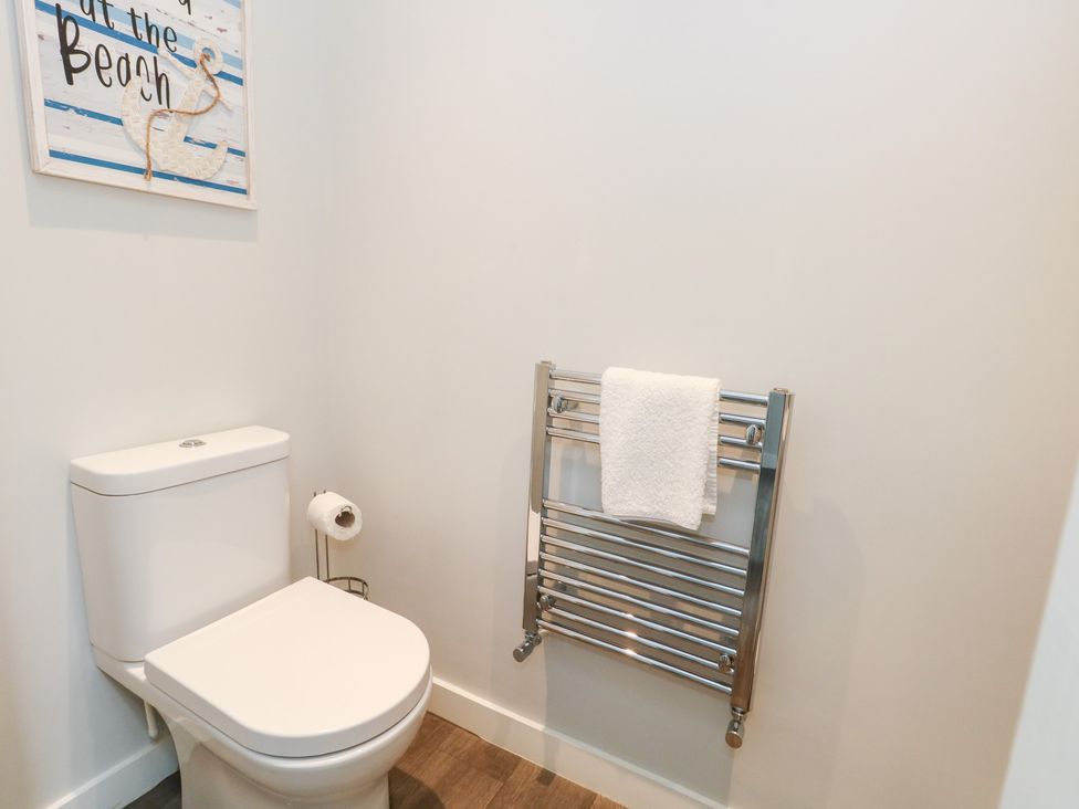 A bathroom with a toilet and towel radiator at Corvesgate in Nottington near Weymouth