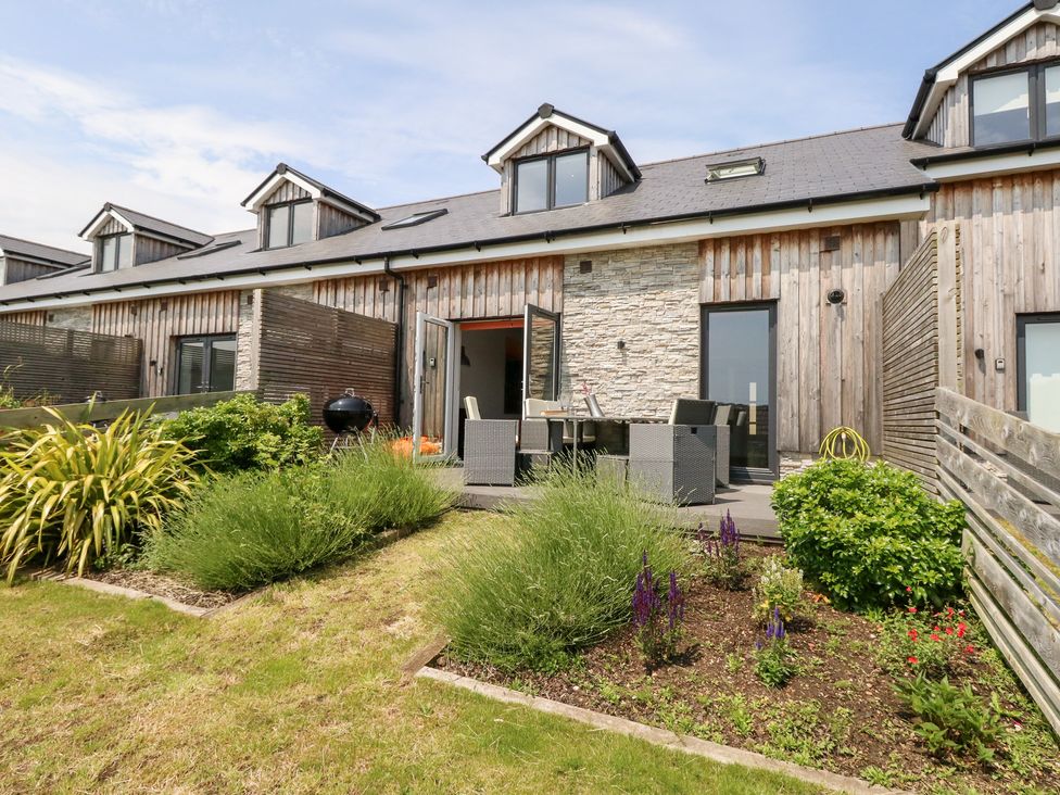 A garden with outdoor seating and plants at Corvesgate Nottington near Weymouth